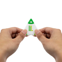 Triangular dice with number 16 held between two hands on a white background