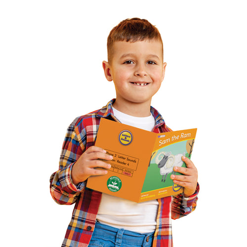 Boy reading a book of Junior Learning BB108 Letters and Sounds Phase 2 Set 2 Fiction