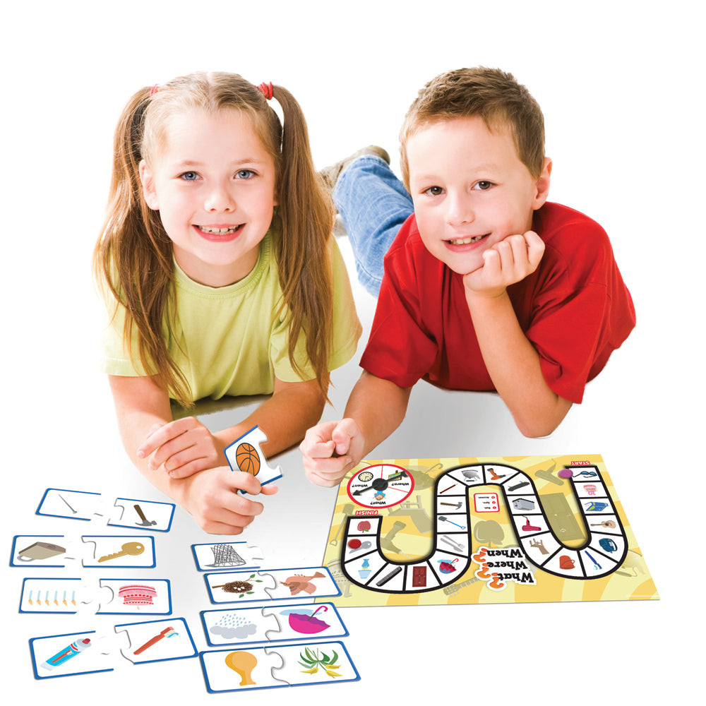 a boy and a girl playing Junior Learning JL407 What, Where, When? board game