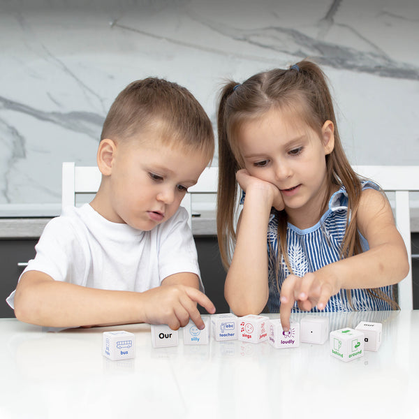 girl and boy playing with Junior Learning JL644 Sentence Cubes